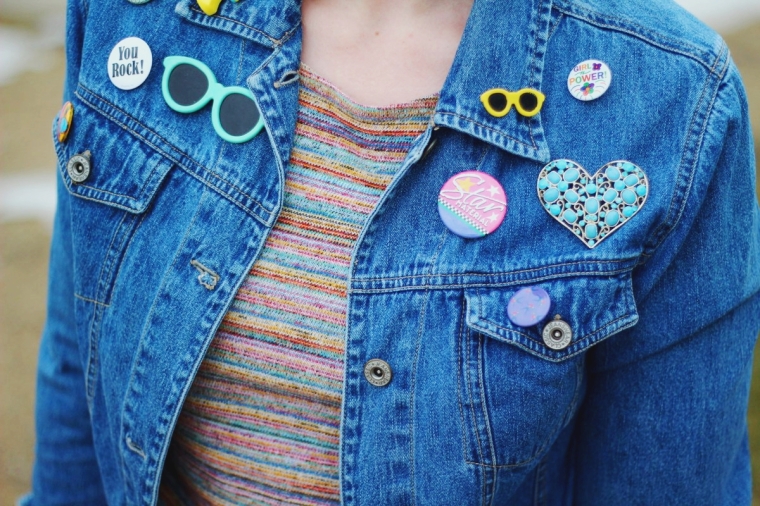 Outfit details: striped multi-colored crop top, denim jacket decked out in thrifted vintage pins and buttons
