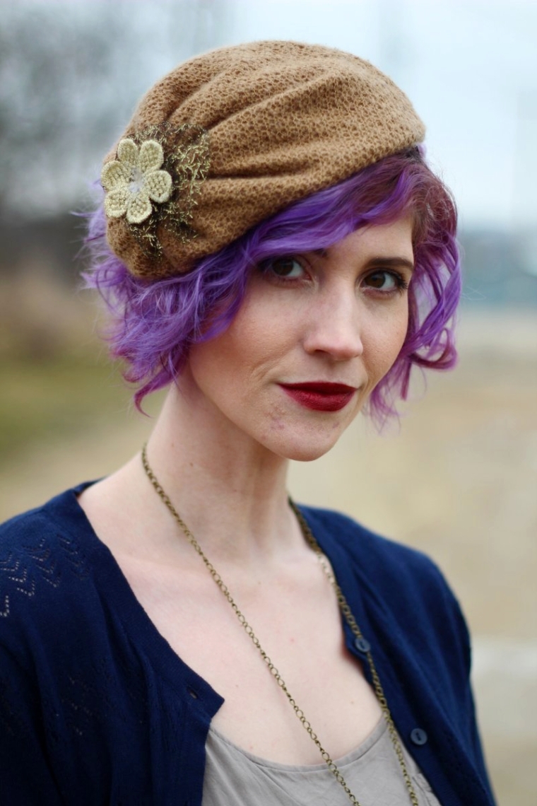 Outfit portrait: tan floppy hat attached to a headband, dark lipstick, lavender hair